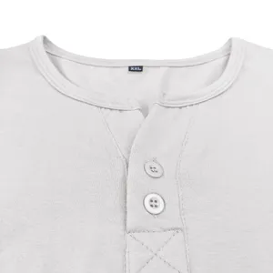 Close-up detail of mens casual henley shirt collar with buttons and size tag in grey.