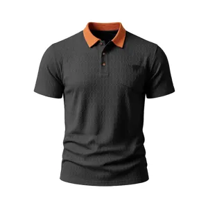 Detailed view of men's short-sleeve polo shirt with contrasting orange collar and pocket.