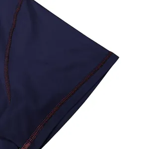Detailed view of dark blue cotton fabric with contrast stitching for men's summer t-shirt.