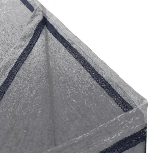 Close-up detail shot of grey fabric with durable dark blue overlock stitching for apparel.