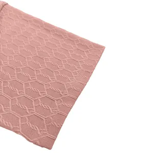 Close up view of pink knitted fabric texture detailing honeycomb pattern for men casual wear