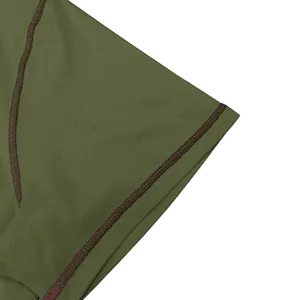 Close-up detail of men's short sleeve t-shirt sleeve with contrast stitching, olive green.