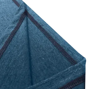 Close-up detail of blue fabric textile with neat dark stitching, fine garment texture view.