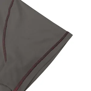 Close-up view of men's cotton t-shirt sleeve showcasing contrast red stitching detail clearly.