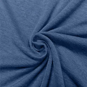 Blue cotton fabric detail close up showing soft knit texture and natural swirl folds.