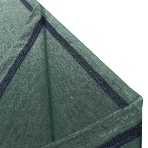 Detailed view of green fabric with dark blue overlock stitching, showcasing craftsmanship.