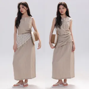 French cotton sleeveless top and long skirt set with lace fringe shawl and straw hat detail.