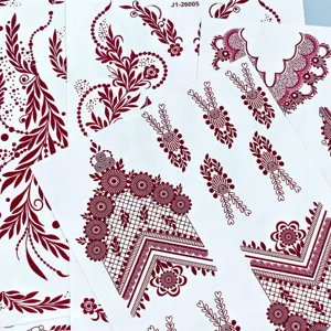 Detailed view of maroon henna temporary tattoo sheets featuring intricate Indian mehndi floral lace designs.