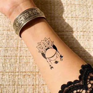 Waterproof temporary tattoo sticker with lotus and celestial moon design for arm body art.