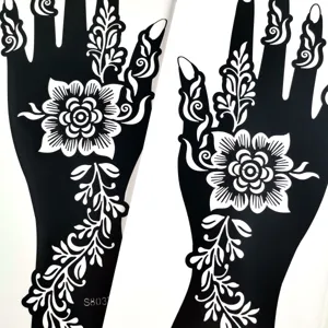 Close-up detail of floral henna tattoo stencils showing intricate hand and finger patterns.