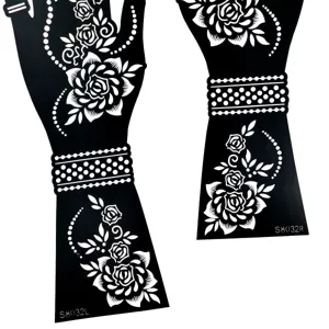Detailed view of black hollow henna tattoo stencil, elegant floral patterns for hand art.