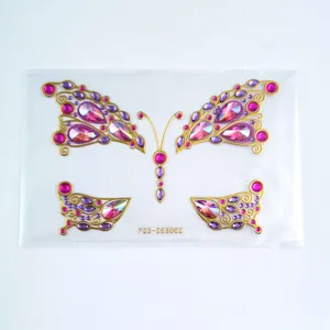 Detailed view of butterfly rhinestone face stickers, sparkling pink and purple gems for festival.