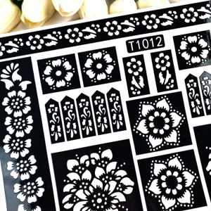 Henna tattoo stencil sheet with intricate floral mandala cutout design for body art painting.