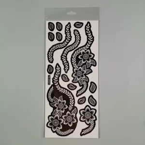 Detailed view of black lace henna tattoo sticker template, floral vine pattern body art sheet.