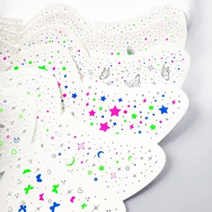 Close-up detail of colorful butterfly and star face tattoo stickers, perfect for party makeup styling.