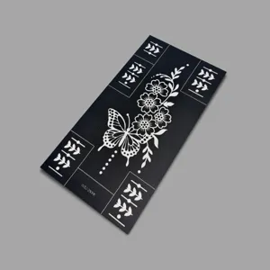 Butterfly floral tattoo stencil detail view showing intricate cutout lines and clean black paper finish