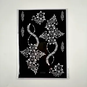 Black temporary tattoo sheet with elegant floral and vine henna style patterns for art.