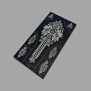 Detailed view of black floral henna tattoo stencil sheet with intricate patterns for art.