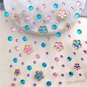 Detailed view of face rhinestone stickers with colorful round gems and gold-edged flower designs.