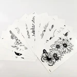 Black style temporary tattoo stickers featuring butterfly and flower designs, detail view.