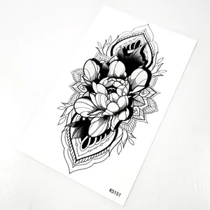 Close-up detail of black and white floral mandala temporary tattoo sticker for body art.