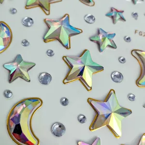 Holographic star and moon rhinestone face stickers close up detail shot for music festival makeup.
