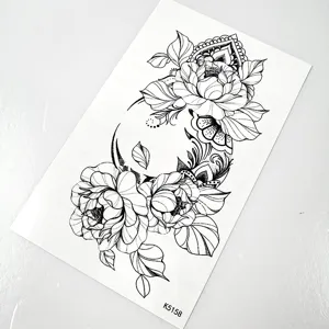 Temporary tattoo sticker detail shot featuring black and white floral line art and design.