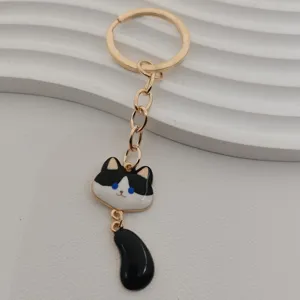 Cute black and white cat metal keychain with dangled tail, gold ring for bag key pendant.