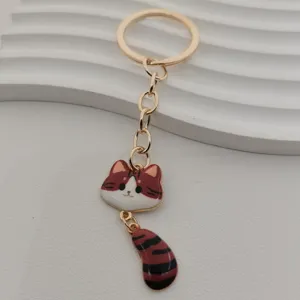 Metal cat keychain with big tail and cute face, stylish gold hardware bag pendant gift.