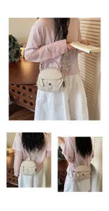 Minimalist canvas shell crossbody bag with top handle and adjustable strap for casual daily use.