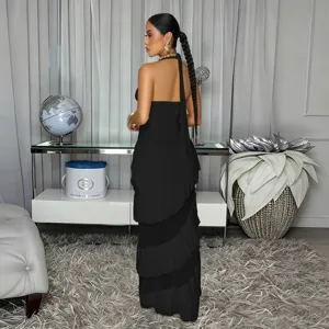 Black sleeveless halter backless maxi dress with tiered ruffle hem and elegant design.
