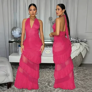 Hot pink halter neck backless maxi dress with tiered ruffles and sheer mesh panel details.