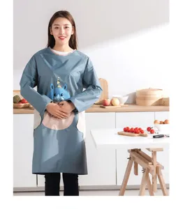 Kitchen waterproof long sleeve smock detail showing cartoon pattern and hand pockets.
