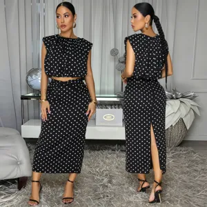 Black and white polka dot sleeveless crop top and midi skirt two-piece outfit set.