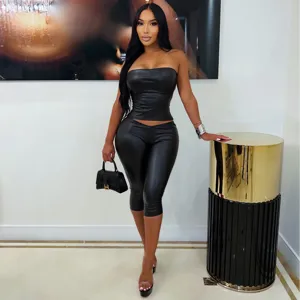 Black faux leather strapless crop top and tight leggings set for women, sexy slim fit outfit.