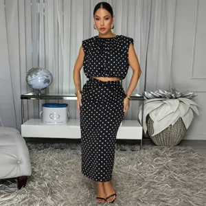 Detailed view of women's black and white polka dot sleeveless crop top and midi skirt set.
