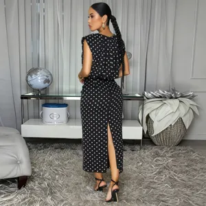 Back view of the black and white polka dot sleeveless top and midi skirt detail.