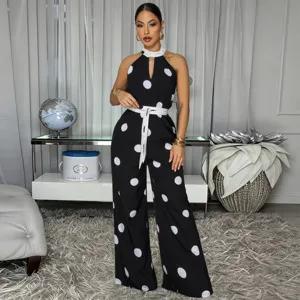 Detail view of stylish black and white polka dot halter neck jumpsuit with matching belt.
