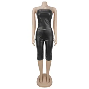 Full body detail view of black faux leather two piece outfit featuring tube top and tight pants.
