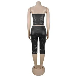 Women black faux leather strapless crop top and fitted capri pants two piece set detail back view