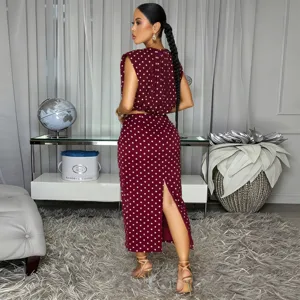 Burgundy polka dot sleeveless crop top and midi skirt two piece set outfit detail view.