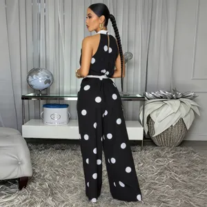 Detail view of a chic black and white polka dot halter sleeveless jumpsuit for women.