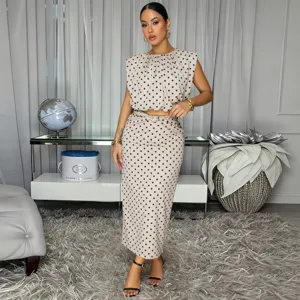 Elegant polka dot sleeveless crop top and midi skirt set for women, chic two-piece outfit.