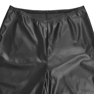 Close-up detail of black faux leather high waist elastic waistband pants texture and design.