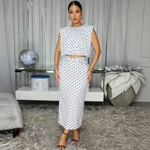 Detailed view of chic black and white polka dot outfit, featuring a crop top and skirt.