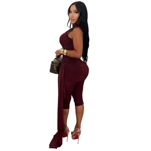 Detail view of sleeveless burgundy ruched jumpsuit with long side drape and slim fit.