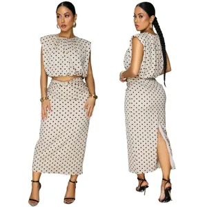 Details of the stylish beige polka dot sleeveless crop top and midi skirt two-piece set.