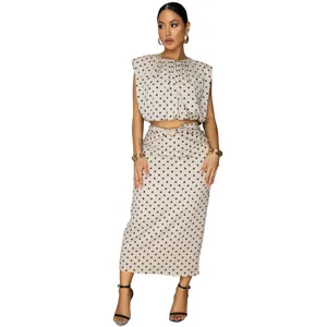 Elegant polka dot sleeveless crop top and midi skirt two-piece outfit for women fashion.