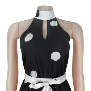 Black and white polka dot halter sleeveless jumpsuit detail, elegant summer fashion design.