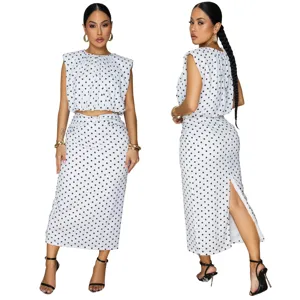 Detailed view of women polka dot two piece outfit, sleeveless top and midi skirt with slit.